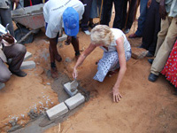 Linda Bullen laying symbolic brick for the new Health Centre